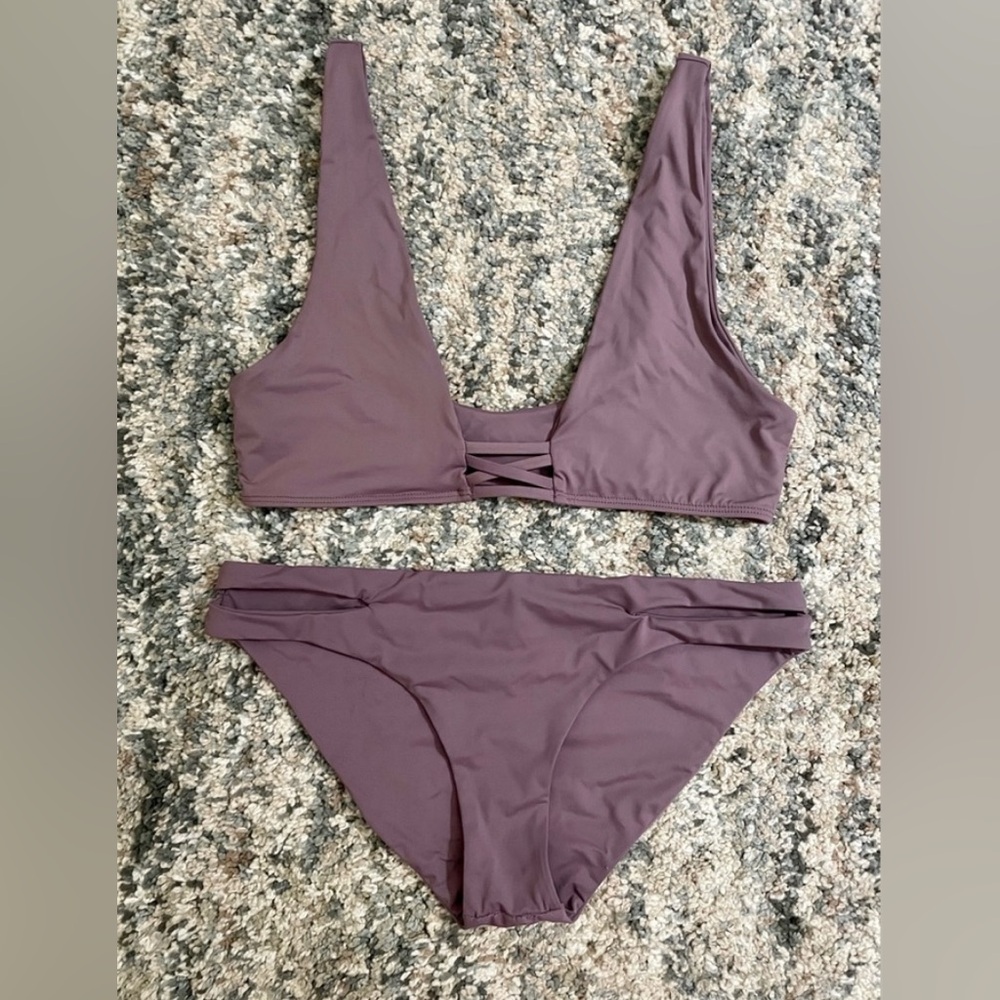 Dippin Daisy’s bikini- top is small and bottoms are medium. Lavender color.